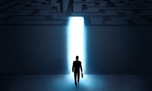A businessman at the entrance to a maze