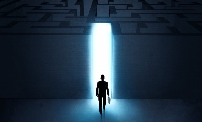 A businessman at the entrance to a maze